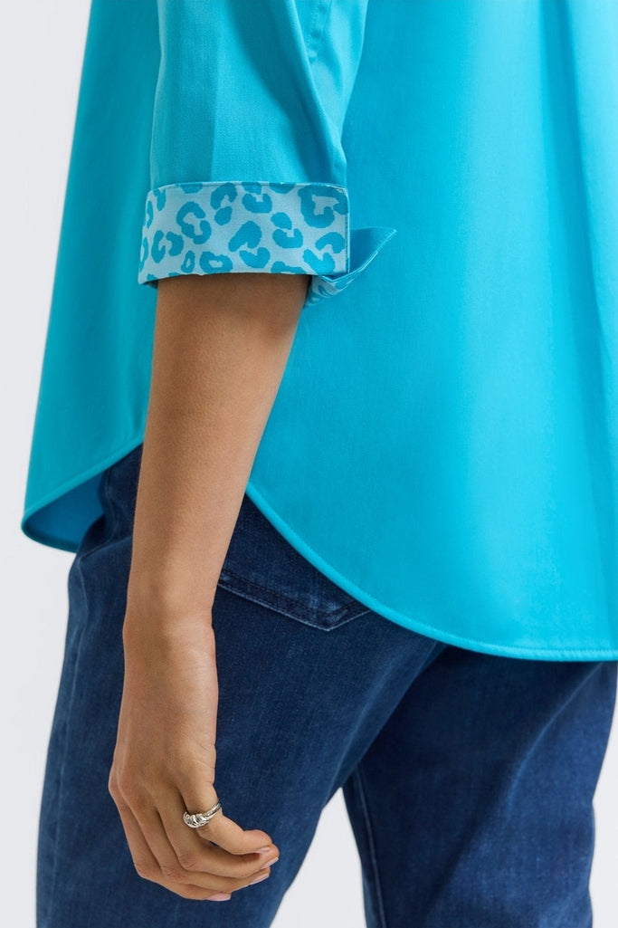 Close up on the folded cuff of the sleeve showing the print on the Margie Stretch Matte Sateen 3/4 Sleeve Shirt #color_ibiza turq