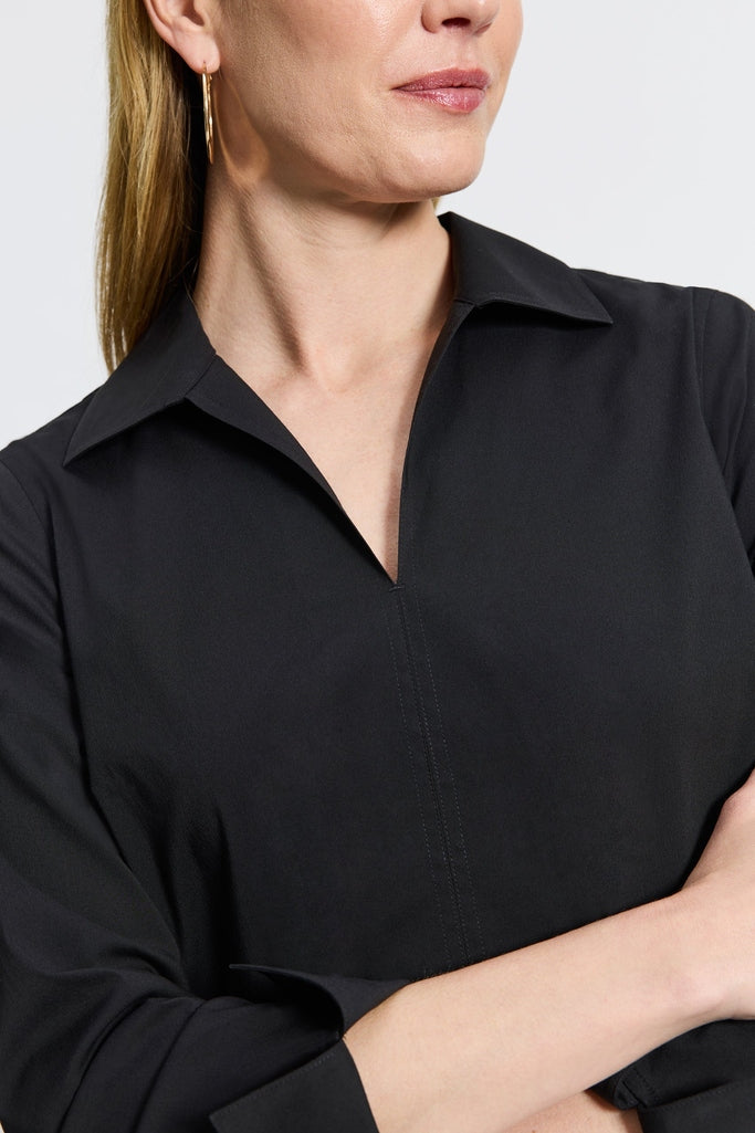 Woman in Foxcroft Agnes black wrinkle-free shirt designed for modern polish and everyday ease. #color_black