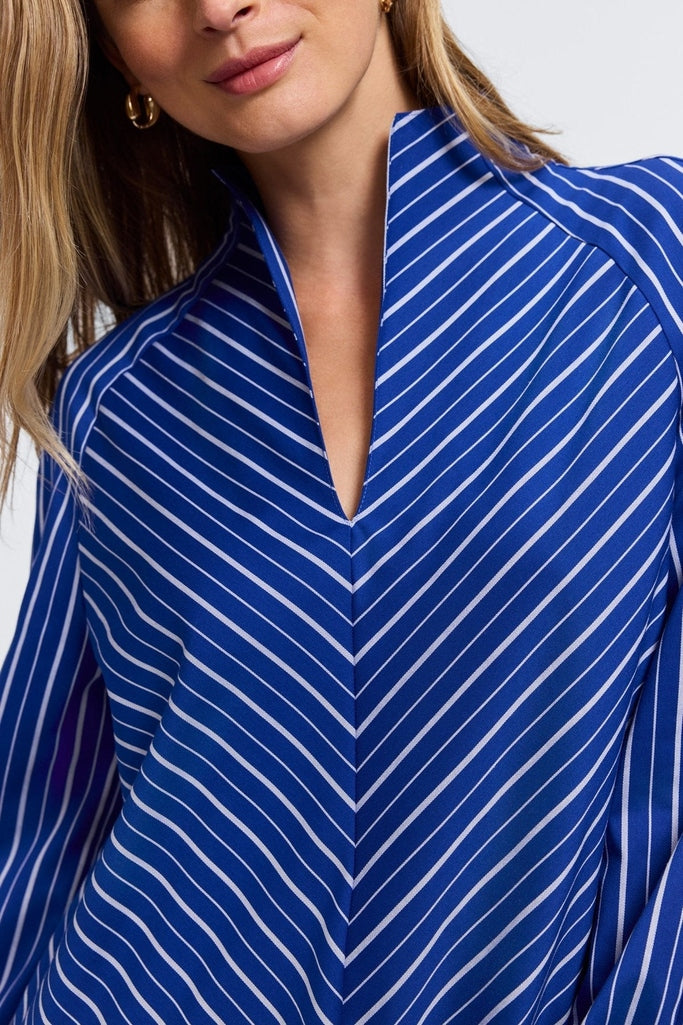 Close up of the front of the Daphne Classic Wide Stripe Long Sleeve Popover Shirt highlighting the split collar and diagonal stripes #color_blue & white wide stripe