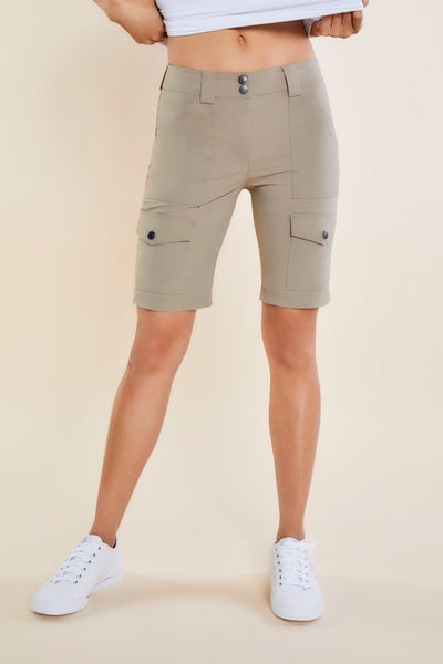 The Best Travel Shorts. Woman Showing the Front Profile of an Apiedi Shorts in Khaki.