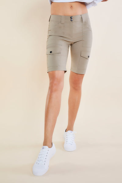 The Best Travel Shorts. Woman Showing the Front Profile of an Apiedi Shorts in Khaki.