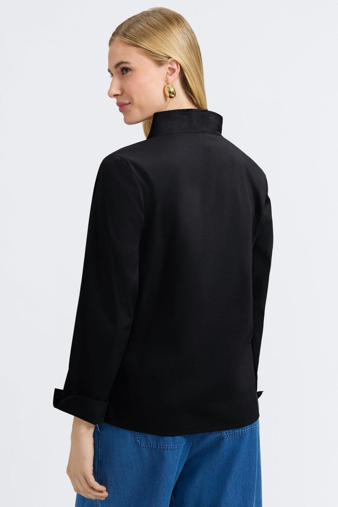 Back view of a woman wearing the Tammy No Iron Stretch Long Sleeve Popover Shirt#color_black