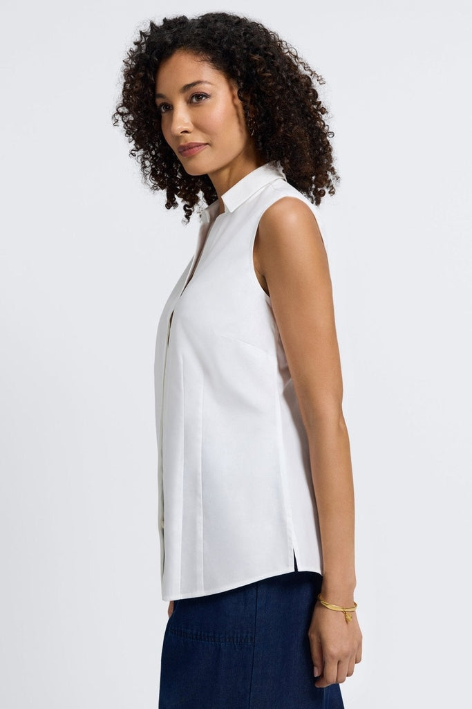 Side view of women wearing Taylor No Iron Stretch Sleeveless Shirt #color_white