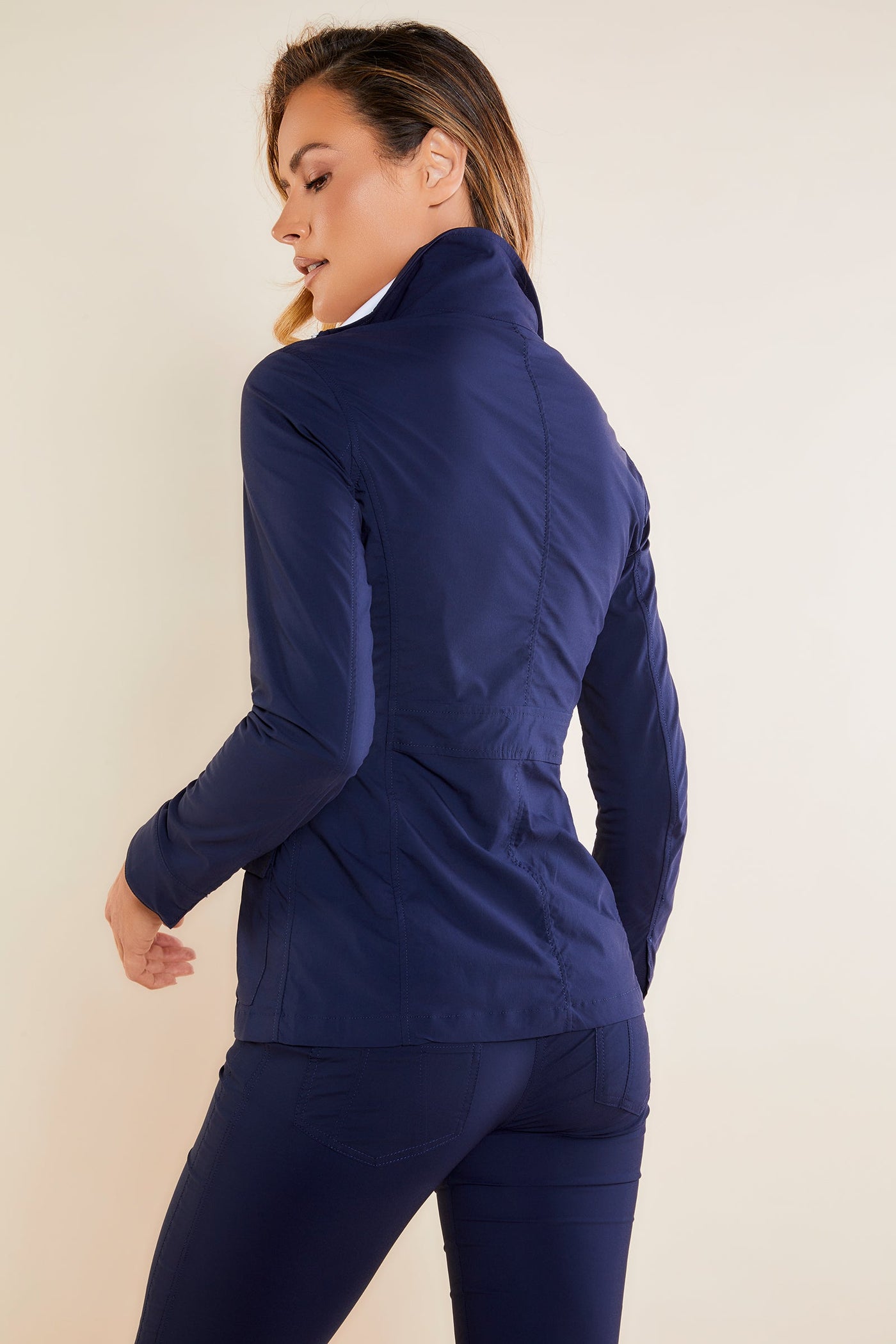 The Best Travel Safari Jacket. Woman Showing the Back Profile of a Safari Jacket in Navy ||