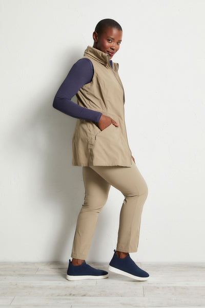 The Best Travel Vest. Woman Showing the Side Profile of a Delaney Travel Vest in Khaki