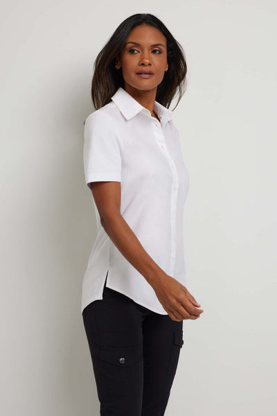 The Best Travel Top. Woman Showing the Side Profile of a Helia Top in White.