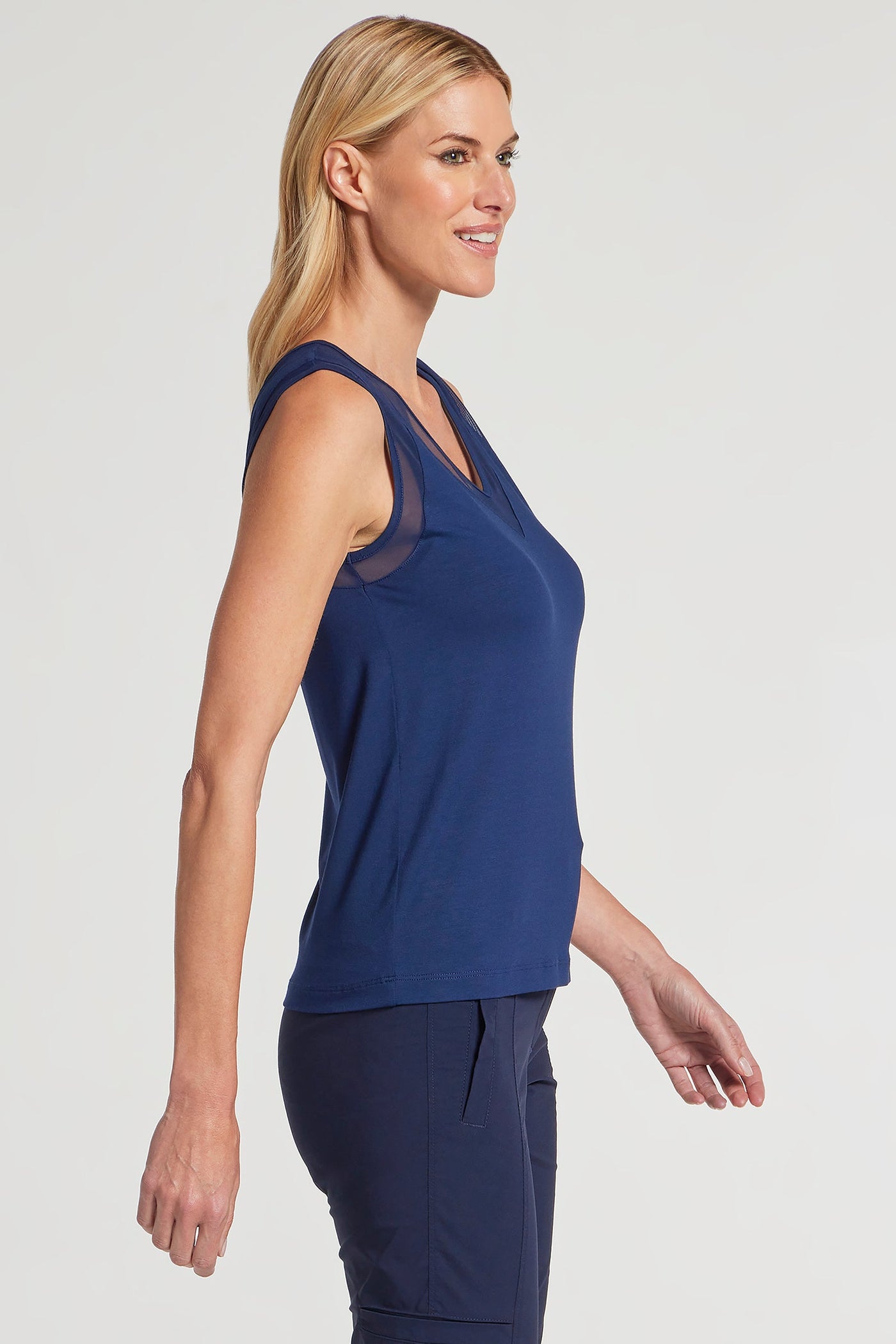 The Best Travel Tank Top. Woman Showing the Side Profile of a Jackson Pima Tank in Navy.