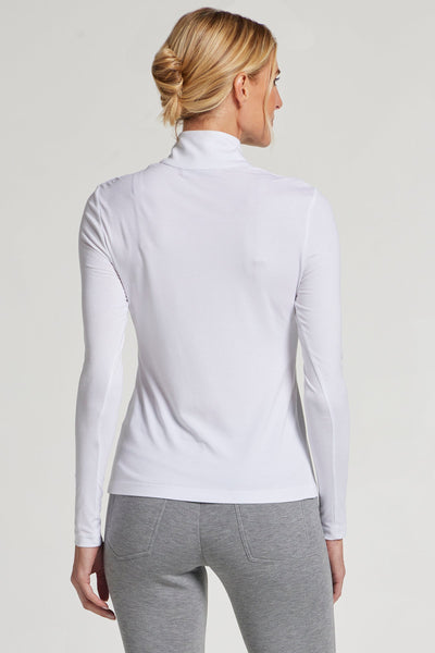 The Best Travel Top. Woman Showing the Back Profile of a Stacey Top in White.