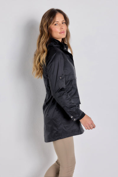 The Best Travel Jacket. Woman Showing the Side Profile of a Ramona Windbreaker Jacket in Black.