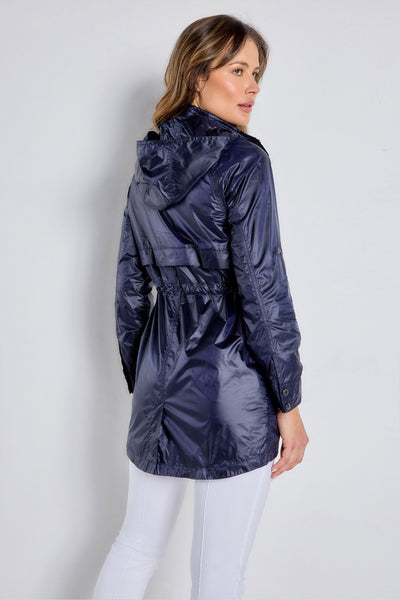 The Best Travel Jacket. Woman Showing the Back Profile of a Ramona Windbreaker Jacket in Navy.