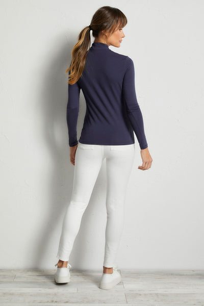 The Best Travel Top. Woman Showing the Back Profile of a Stacey Top in Navy.