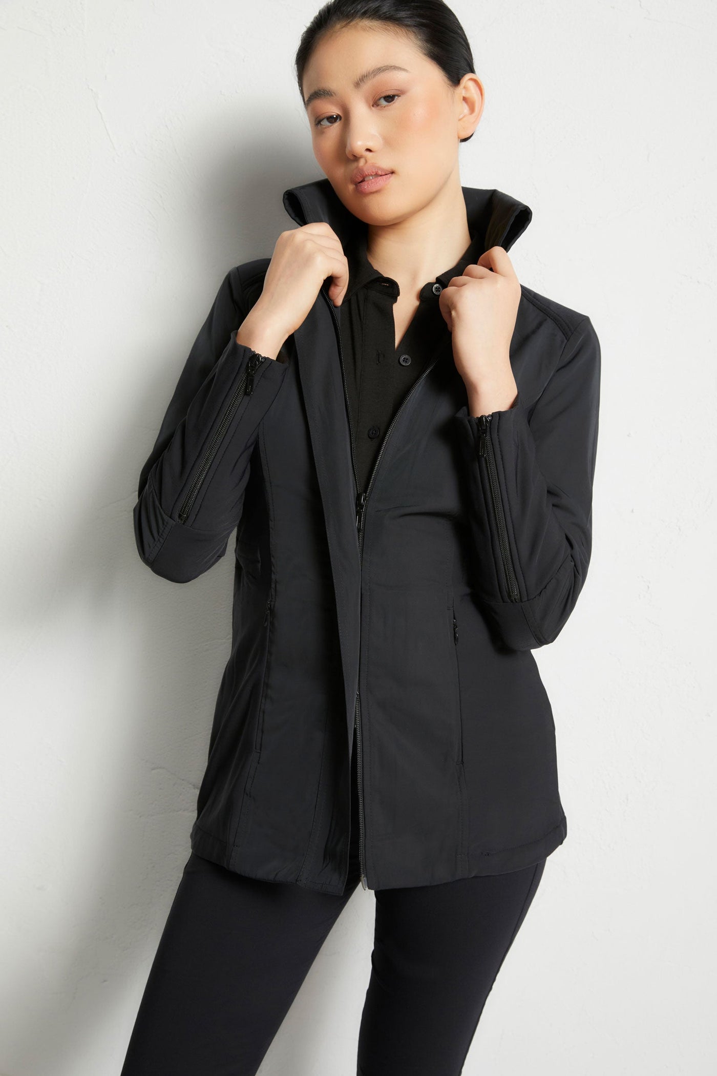 The Best Travel Jacket. Woman Showing the Front Profile of a Travel City Slick Jacket in Black