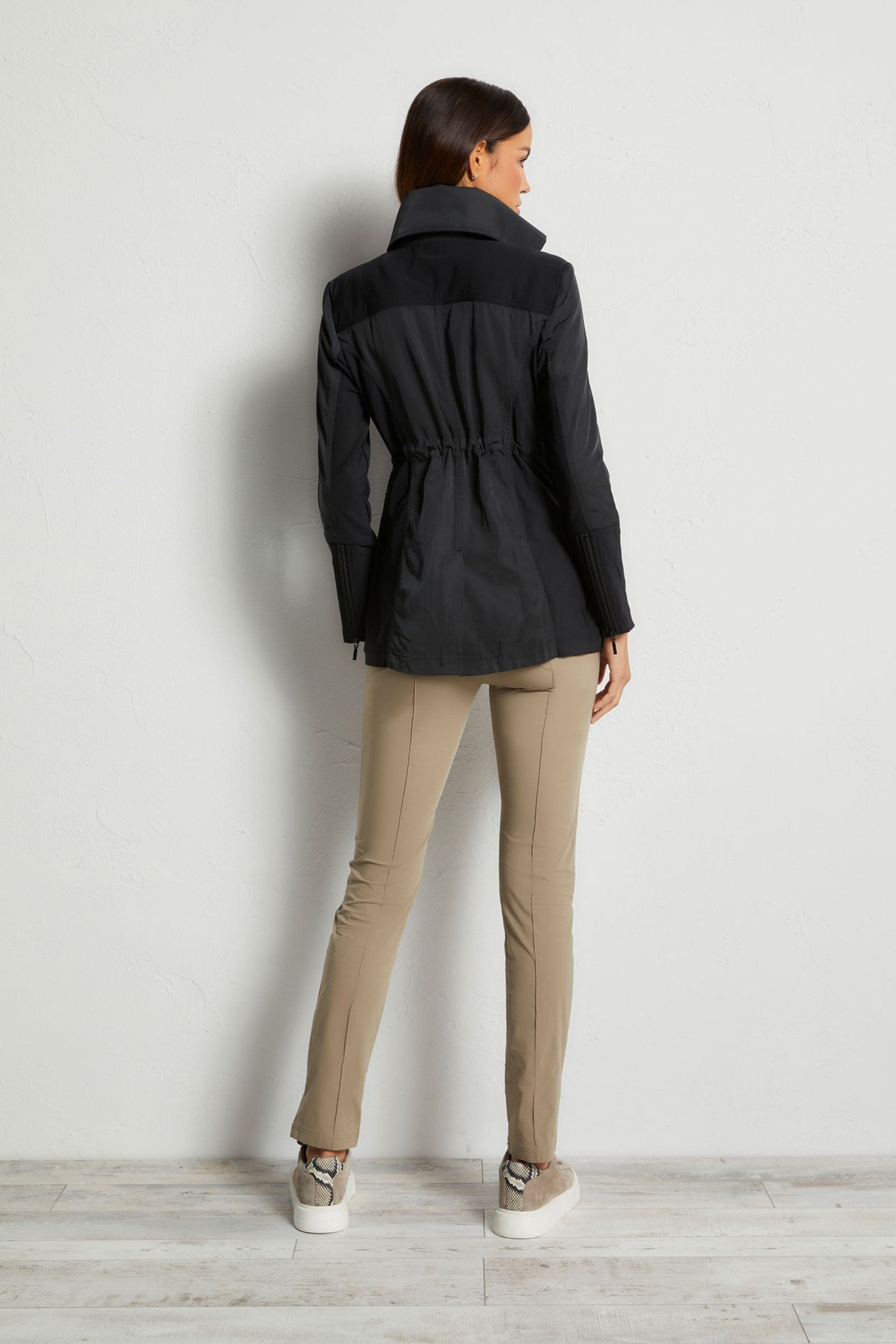 The Best Travel Jacket. Woman Showing the Back Profile of a Travel City Slick Jacket in Black