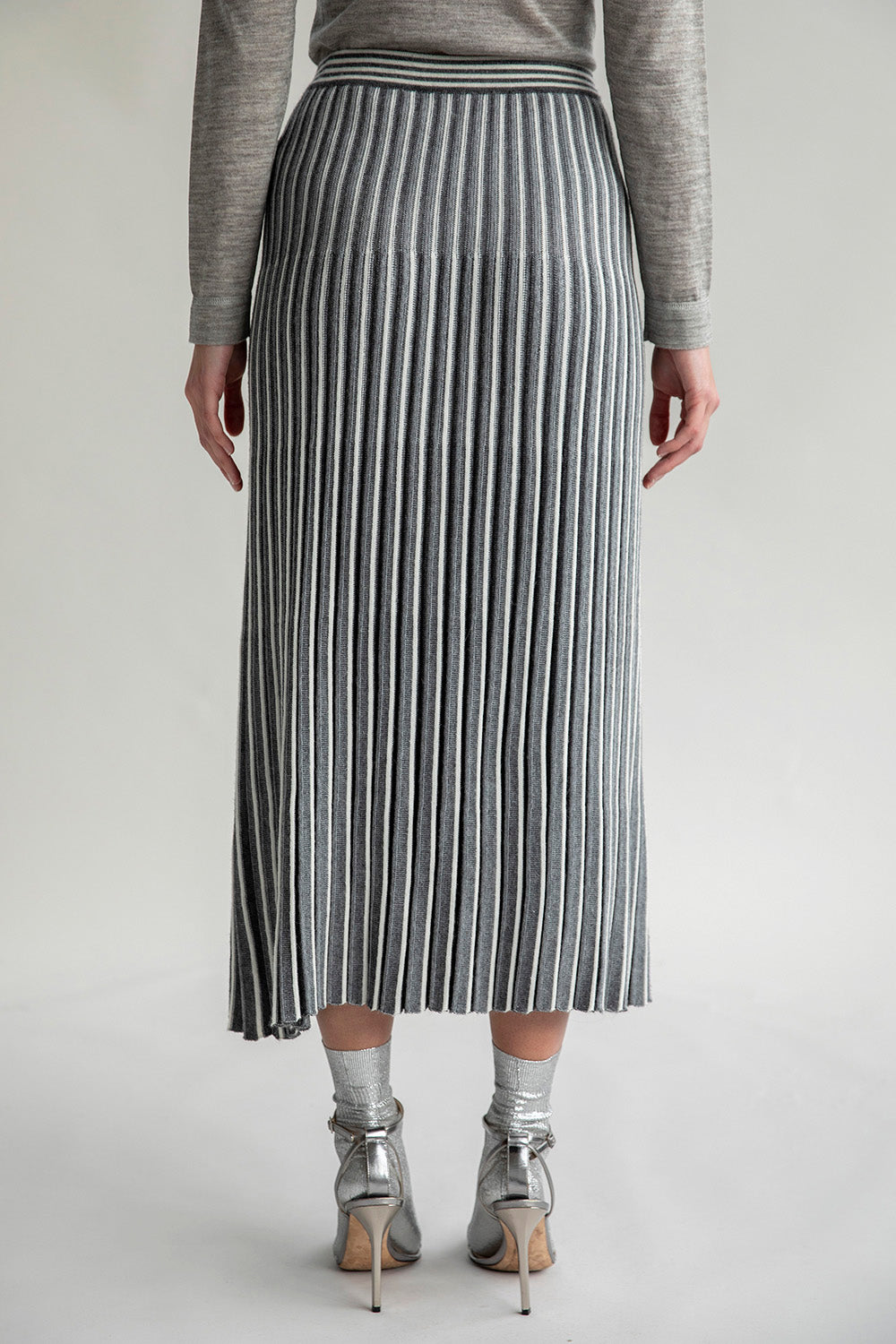 Back view of the Adeline Skirt, highlighting the pleated details and contrasting stripe design.