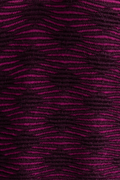 Detail shot of the Amelie Polo showcasing the monochromatic textured pattern in fuchsia and aubergine. Ethically made from baby alpaca and cotton.