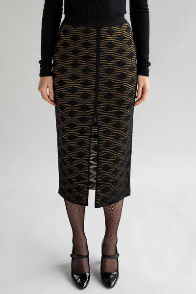 Slim-fitting golden black pencil skirt with a subtle pattern and front slit, styled to show a smooth, streamlined look when worn as intended.