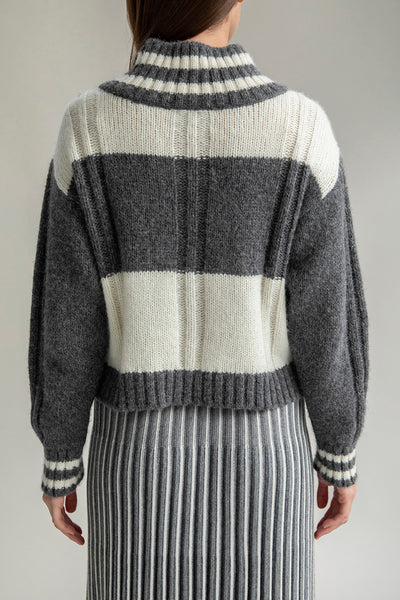 Back view of the Kari V-neck pullover, highlighting its unique checkered pattern and comfortable fit. Perfect for pairing with the Adeline skirt.