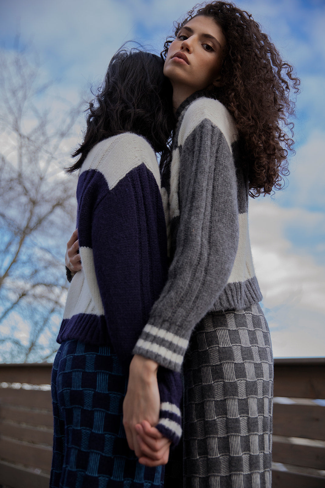 Models wearing the Kari Plaid Pullover outdoors, highlighting the sweater's warmth and evoking a cozy hygge atmosphere.