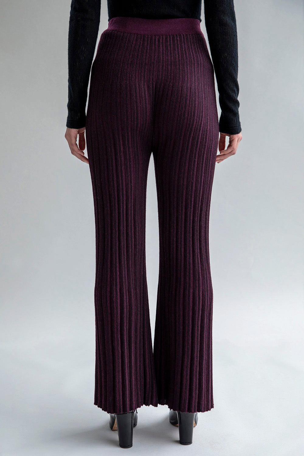 Full back view of a woman wearing Marcelle Trousers, showcasing the form-fitting design and mid-weight fabric.