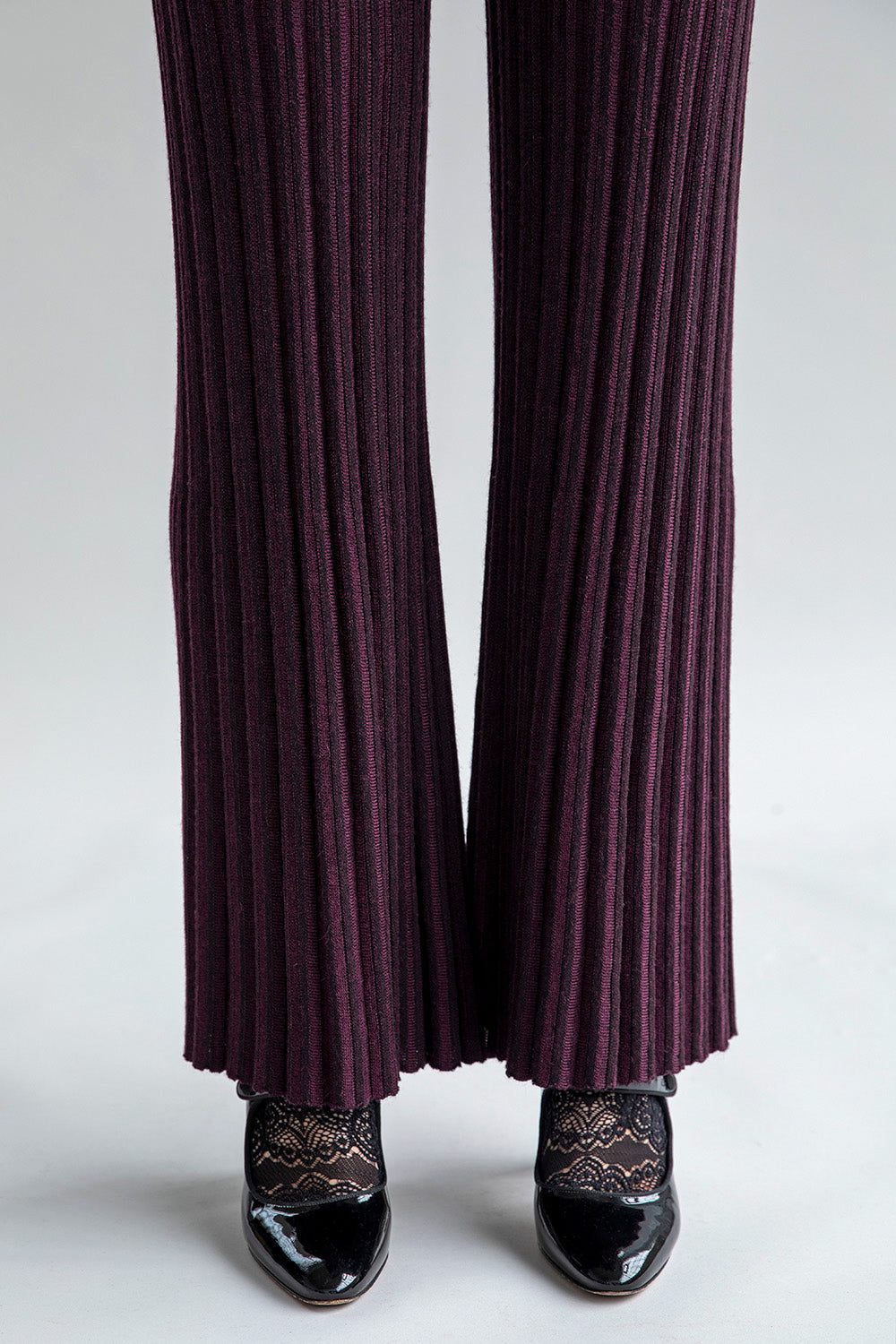 Close-up of Marcelle Trousers in aubergine, highlighting the texture and materials: polyamide, baby alpaca, and silk.