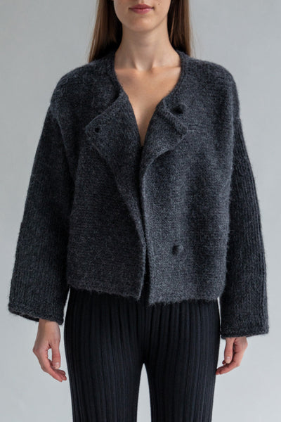 Front view of the Momo Handknit Cardigan in Charcoal hand-knitted by Peruvian artisans from soft alpaca blend yarn with a textured stitch. Hand-crocheted buttons and a versatile design make it a cold-weather essential.