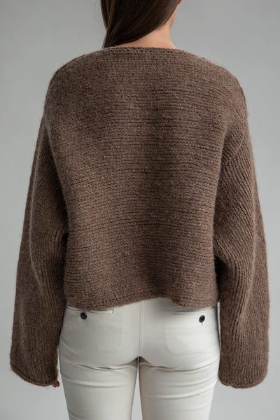 Back view of the Momo Handknit Cardigan in Saddle, highlighting its relaxed, cropped shape and beautiful heavyweight fabric ethically sourced in Peru.