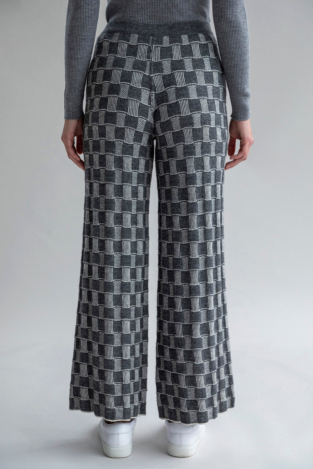 Back view of Zoe Trousers, highlighting the graphic-checked pattern in the darker colorway.