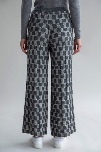 Back view of Zoe Trousers, highlighting the graphic-checked pattern in the darker colorway.
