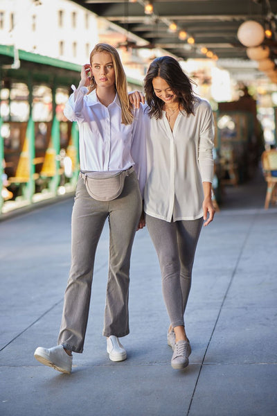 color=Mid Grey, two women's models in New York NYC subway wearing gray leggings and white button up shirts