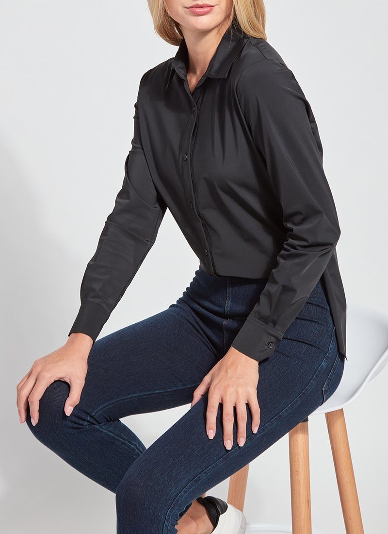 color=Black, seated side view, slim fit women’s button up shirt with curved hem, made with wrinkle resistant microfiber