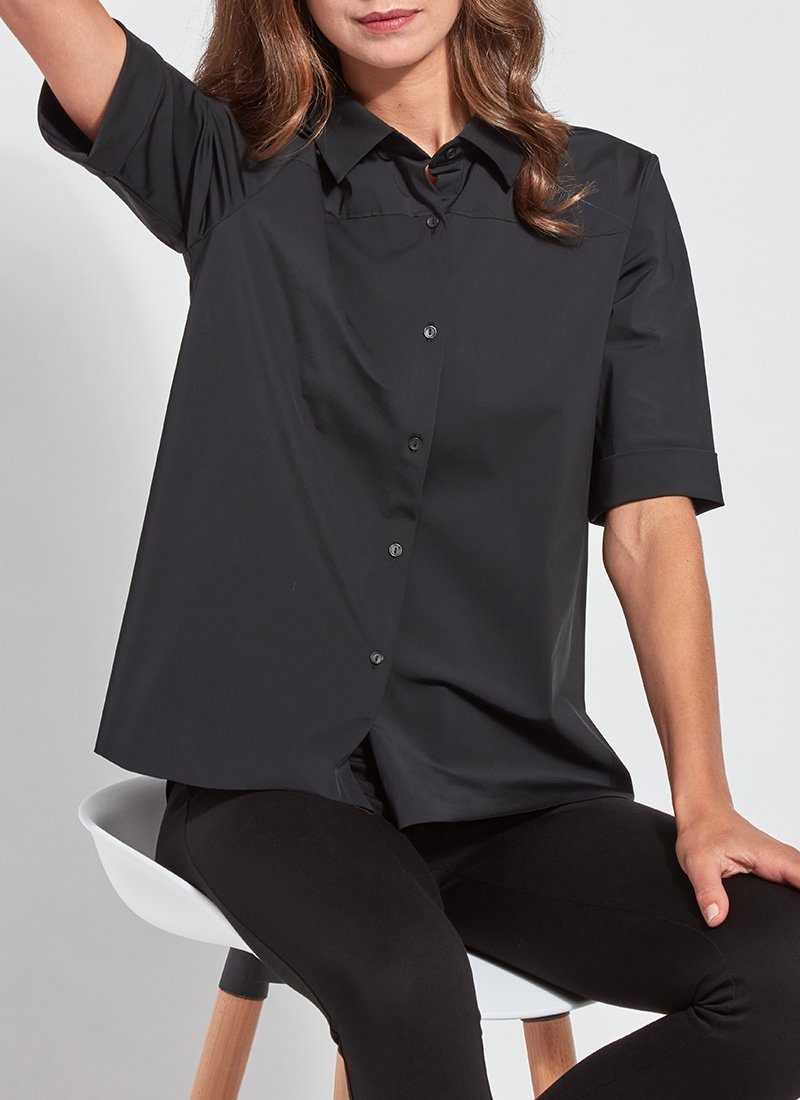 color=Black, seated front view, slim fit women’s short sleeve button up shirt in wrinkle resistant microfiber