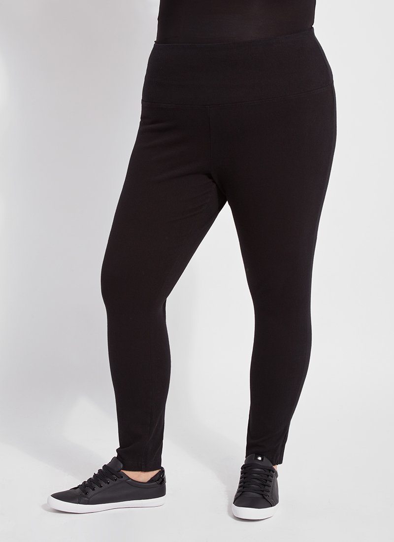 color=Black, front view, plus size denim skinny jean leggings with concealed smoothing waistband for flattering fit