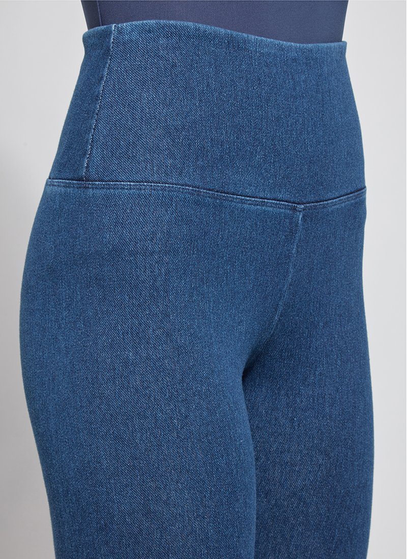 color=Mid Wash, Front, angled detail shot of mid wash blue cotton and spandex leggings with concealed signature waistband