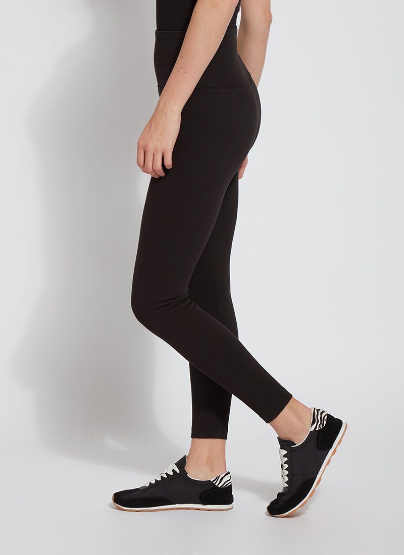 color=Black, Side view of black cotton and spandex leggings with concealed slimming signature waistband, from waist down
