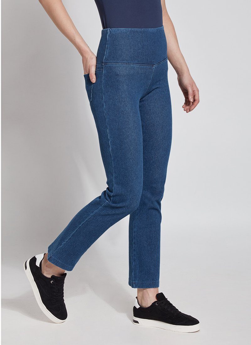 color=Mid Wash, Angled front view of mid wash blue denim straight leg jean leggings with patented concealing waistband, seen from waist down