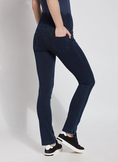 color=Indigo, Angled rear view of indigo denim straight leg jean leggings with patented concealing waistband